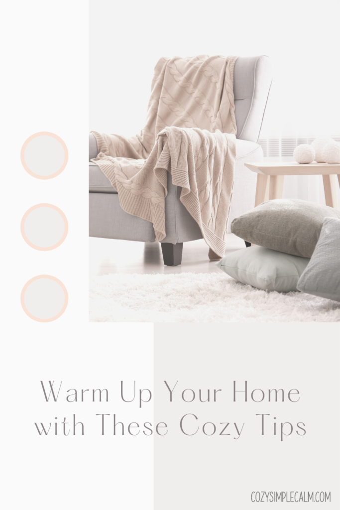 Text: Warm up your home with these cozy tips. Image of blanket on cozy chair surrounded by pillows