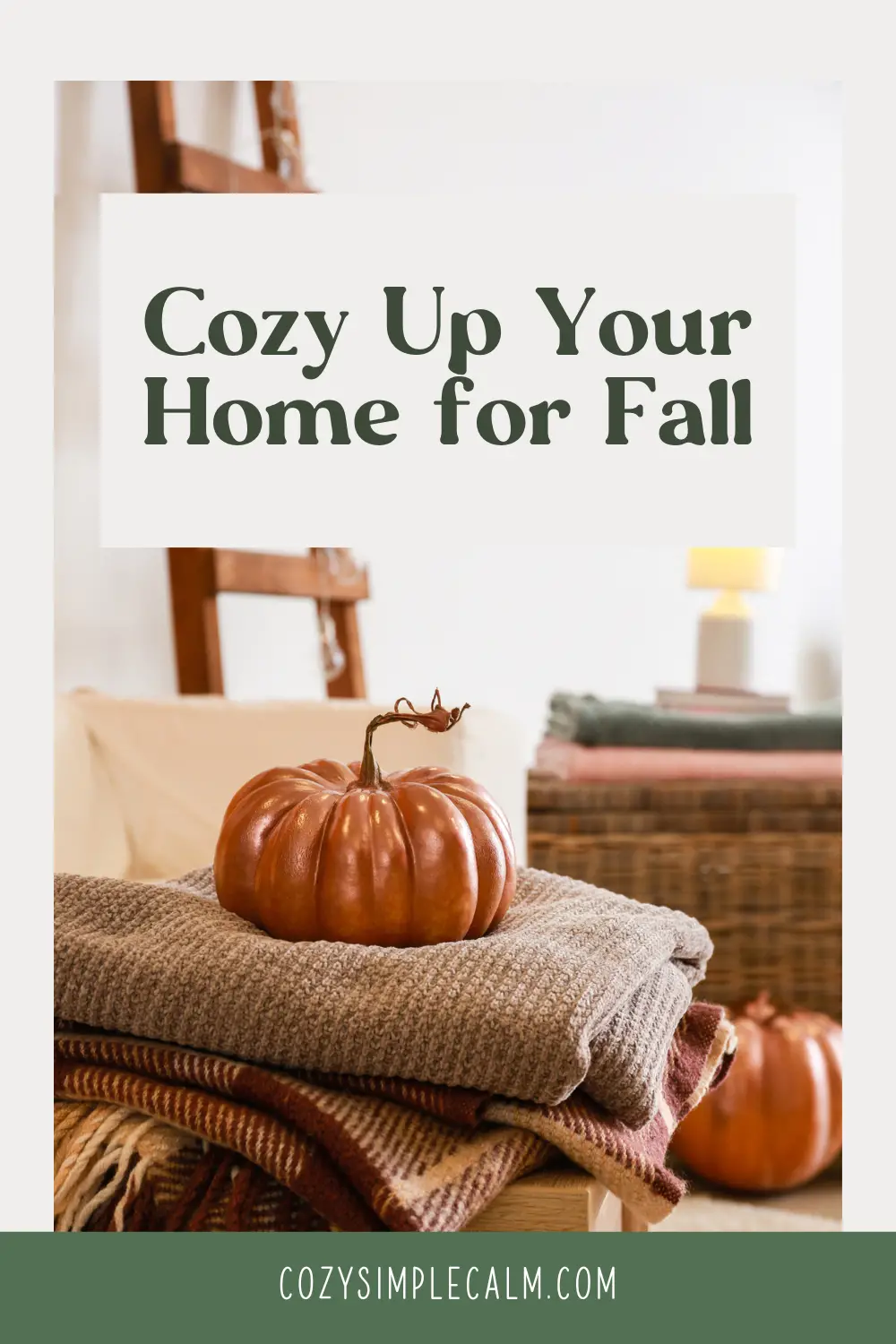 Image of ceramic pumpkin sitting on stacked fall blankets - Text overlay: Cozy up your home for fall - cozysimplecalm.com