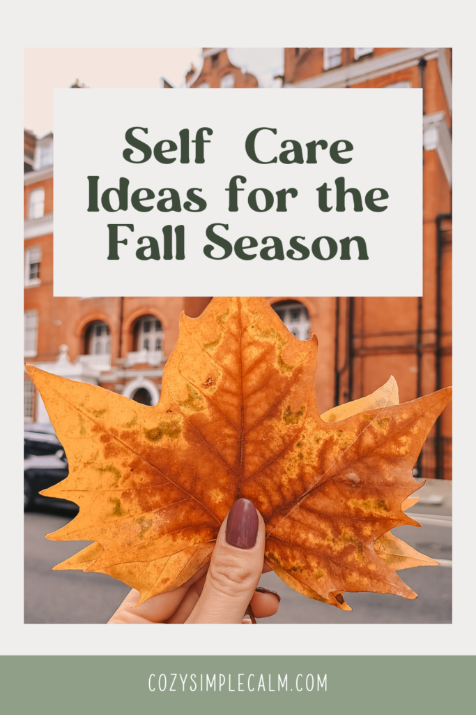 Image of woman's hand with nail polish holding fall maple leaves - Text overlay: Self Care Ideas for the Fall Season - cozysimplecalm.com
