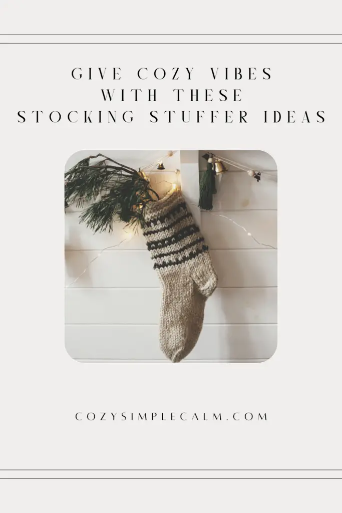 Image of christmas stocking with greenery on white wood background - Text: Give cozy vibes with these stocking stuffer ideas - cozysimplecalm.com